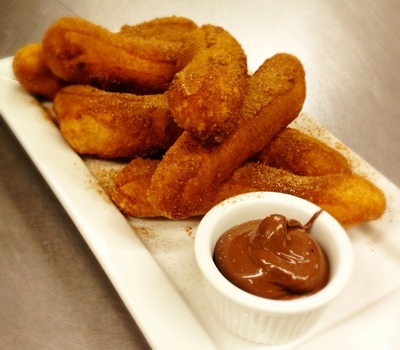 nutella fries: 6 strips of fried dough tossed in saigon cinnamon sugar with a cup of nutella dip