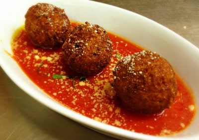 arancini: 3 fried risotto balls with speck, scallions and tomato sauce